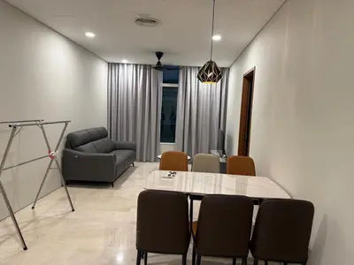 a living room with a table and chairs and a couch at Dawn Legacy Suite in Kuala Lumpur