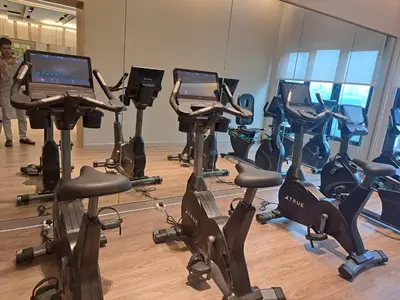 a gym with several treadmills and exercise bikes at Agile Malaysia Apartment KL in Kuala Lumpur
