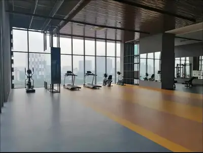 an empty gym with cardio equipment in a large room with windows at Cozy Kenwingston Setapak 3BR & 2BR 5-8 Pax l Parking & Netflix 3201 in Kuala Lumpur