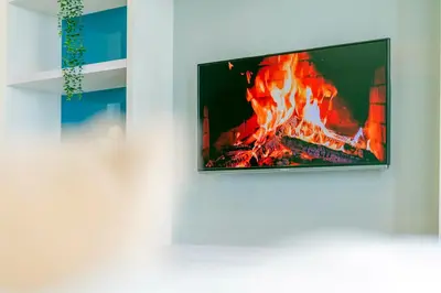 a tv hanging on a wall next to a fire at Platinum in Kuala Lumpur