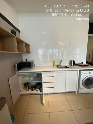 a kitchen with a sink and a washing machine at NiceStay in Kuala Lumpur