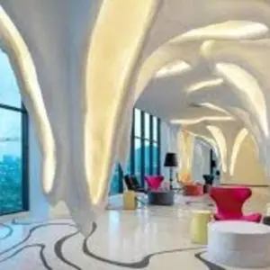 a living room with a white room with red chairs at NiceStay in Kuala Lumpur