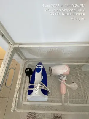 a box with a pair of shoes and a hair dryer at NiceStay in Kuala Lumpur