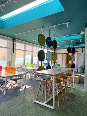 a room with tables and chairs and a blue ceiling at COzy Suite KL Sentral By Riveria City in Kuala Lumpur