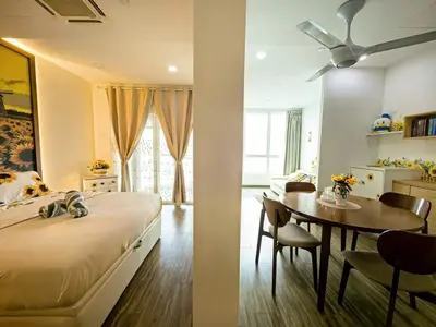 a bedroom with a bed and a table and a dining room at Setapak Central KL - Zetapark Summer Suites in Kuala Lumpur