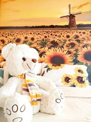 two teddy bears sitting next to a field of sunflowers at Setapak Central KL - Zetapark Summer Suites in Kuala Lumpur