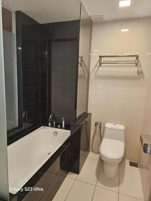 a bathroom with a tub and a toilet and a sink at Executive Suite Dua Sentral in Kuala Lumpur
