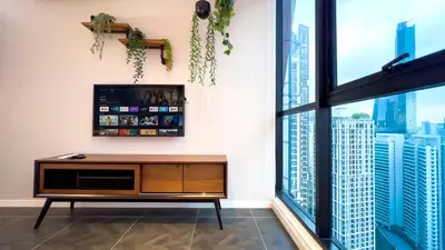 a living room with a tv and a large window at Scarletz Suite KLCC by Light House 1 in Kuala Lumpur