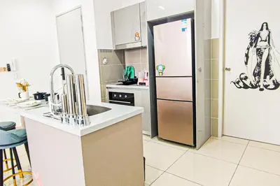 a kitchen with a sink and a refrigerator at Trion1 in Kuala Lumpur