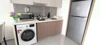 a kitchen with a washing machine and a washer at Agile Service Residence by TRX KLCC in Kuala Lumpur