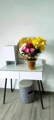 a vase of flowers sitting on top of a table at Agile Service Residence by TRX KLCC in Kuala Lumpur