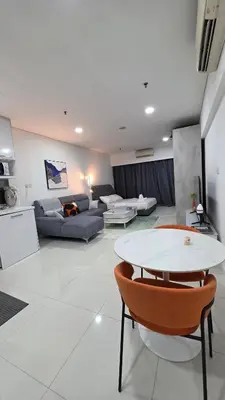 a living room with a couch and a table at Summer Suites Klcc by Sikka in Kuala Lumpur