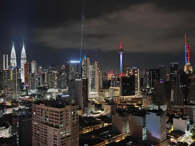 a city skyline at night with a lot of tall buildings at Chambers Vista Suites Urban Haven KLCC in Kuala Lumpur