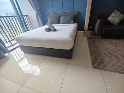 a bedroom with a bed with a stuffed animal on it at Chambers Vista Suites Urban Haven KLCC in Kuala Lumpur