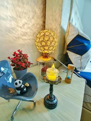 a table with a lamp and a chair and an umbrella at Master Room, Razak City Residence in Kuala Lumpur