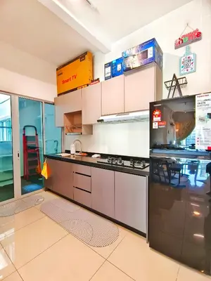 a kitchen with a stove and a refrigerator at Master Room, Razak City Residence in Kuala Lumpur