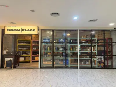 a store with glass doors and shelves of alcohol at The Luxe & Colony KLCC By LuxeHub in Kuala Lumpur