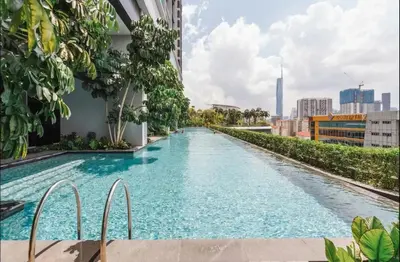 a swimming pool in the middle of a building at trion kl TRX klcc view in Kuala Lumpur