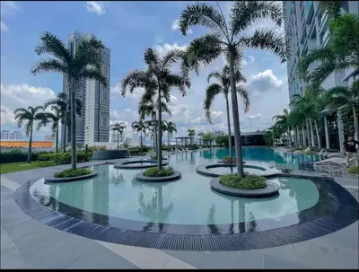 a pool with palm trees in a resort at trion kl TRX klcc view in Kuala Lumpur