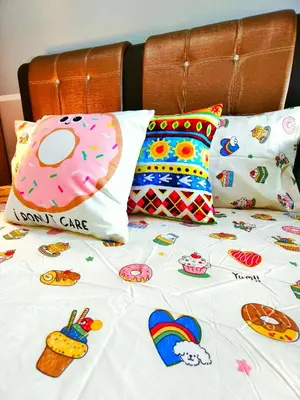 a bed with pillows and a pink donut pillow at Master Room at Razak City Residence in Kuala Lumpur