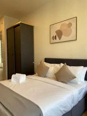 a large bed in a bedroom with a black cabinet at Staybliss At Ceylonz Suites KLCC in Kuala Lumpur