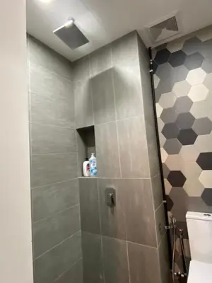 a bathroom with a shower stall with a toilet at Staybliss At Ceylonz Suites KLCC in Kuala Lumpur