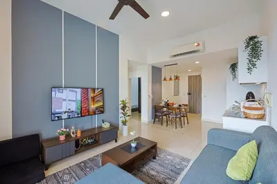 a living room with a blue couch and a tv at Premium Stay Central KL Next to TRX Mall & IKEA in Kuala Lumpur