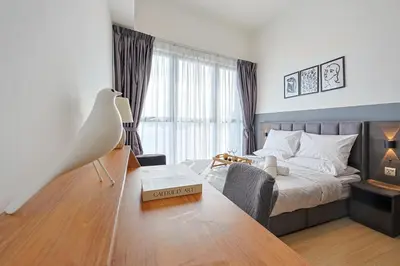 a bedroom with a bed and a table with a box on it at Premium Stay Central KL Next to TRX Mall & IKEA in Kuala Lumpur