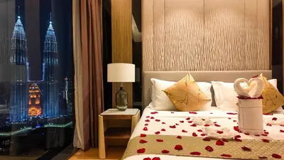 a bedroom with a bed with a view of the city at Imperial Residences KLCC - MK HOME in Kuala Lumpur