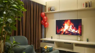 a living room with a fireplace and a television with balloons at Imperial Residences KLCC - MK HOME in Kuala Lumpur