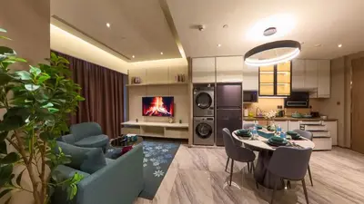 a kitchen and living room with a table and a fireplace at Imperial Residences KLCC - MK HOME in Kuala Lumpur