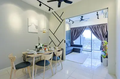 a dining room and living room with a table and chairs at Luxurious TRX Corner Dual Balconies 2 Bedrooms in Kuala Lumpur