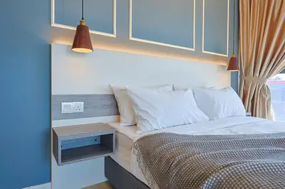 a bedroom with a bed with a night stand next to it at Luxurious TRX Corner Dual Balconies 2 Bedrooms in Kuala Lumpur