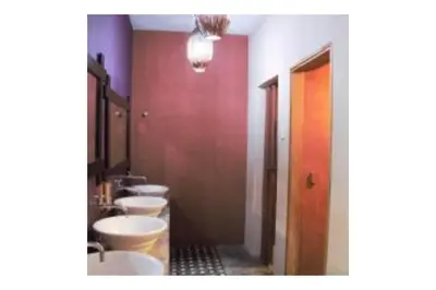 a bathroom with four sinks and a row of toilets at The Explorers Guesthouse and Hostel in Kuala Lumpur