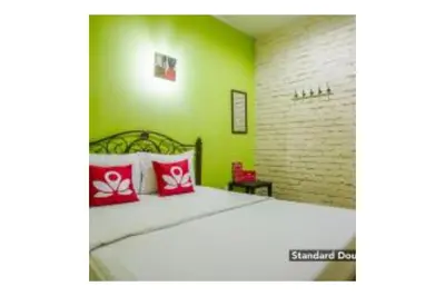 a bedroom with a large bed with red pillows at The Explorers Guesthouse and Hostel in Kuala Lumpur
