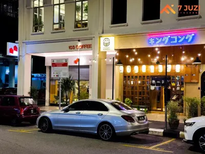 a silver car parked in a parking lot in front of a building at SkyPool KLCC 2BR Platinum Suite D33F with Netflix in Kuala Lumpur
