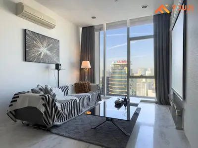 a living room with a couch and a large window at SkyPool KLCC 2BR Platinum Suite D33F with Netflix in Kuala Lumpur