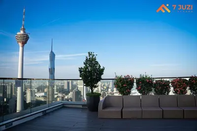 a couch on a roof with a view of the city at Sky Pool KLCC 2BR Platinum Suite C33 with Netflix in Kuala Lumpur
