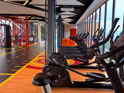 a gym with rows of treadmills and ellipticals at Majestic Premium suites KLCC in Kuala Lumpur