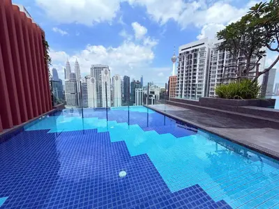 a swimming pool on the roof of a building with a city at Majestic Luxury Suites KLCC By Home stay in Kuala Lumpur