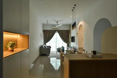 a kitchen and living room with a table and a living room at Jln Razak Mansion, in Kuala Lumpur