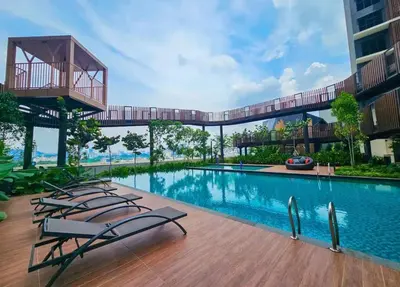 a swimming pool with lounge chairs next to a building at trion Klcc 2 bedroom apartment in Kuala Lumpur