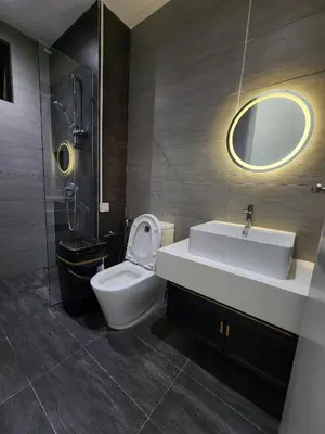 a bathroom with a sink and a toilet and a mirror at trion Klcc 2 bedroom apartment in Kuala Lumpur