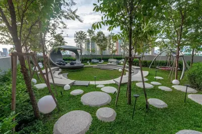 a park with a playground with rocks in the grass at KLCC Scarletz Residence Near By KL in Kuala Lumpur