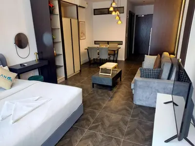 a living room with a bed and a couch and a table at KLCC Scarletz Residence Near By KL in Kuala Lumpur