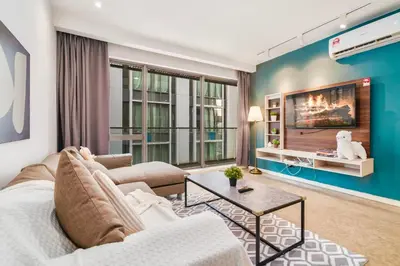 a living room with a couch and a tv at Bintang Fairlane near Pavillion Bukit Bintang in Kuala Lumpur