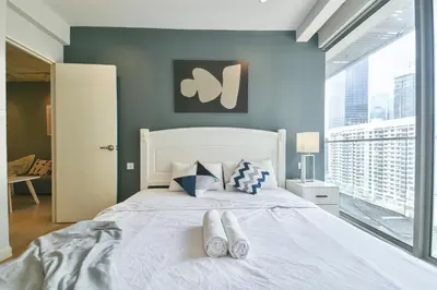 a bedroom with a white bed with shoes on it at Bintang Fairlane near Pavillion Bukit Bintang in Kuala Lumpur