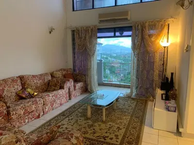 a living room with a couch and a table at Urban bloom stays in Kuala Lumpur