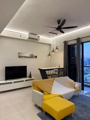 a bedroom with a bed and a flat screen tv at klcc 2 bedroom trion in Kuala Lumpur