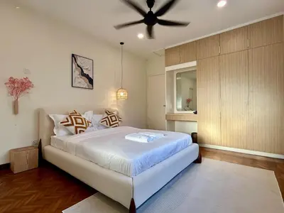 a bedroom with a bed with a ceiling fan at The Little Bali - 6Room - 18Pax in Kuala Lumpur
